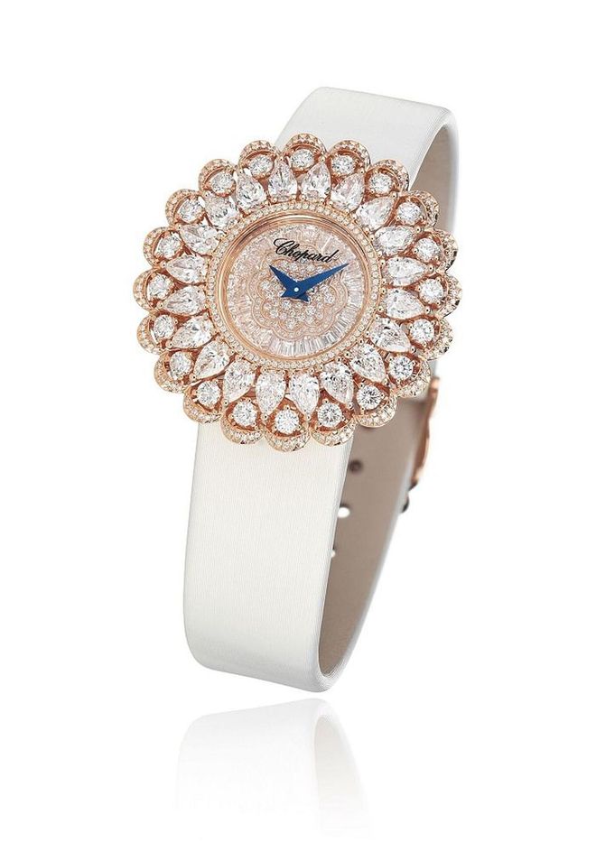 A rose-gold timepiece set with 5.5 carats of pear shaped diamonds. 2.8 carats of brilliant cut diamonds,and tapered baguette-cut and marquise-cut diamonds on a brushed canvas strap. <b>Chopard, Price Upon Request</b>