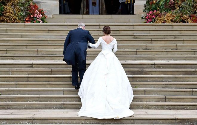Princess Eugenie walking up the steps into St. George's Chapel.
