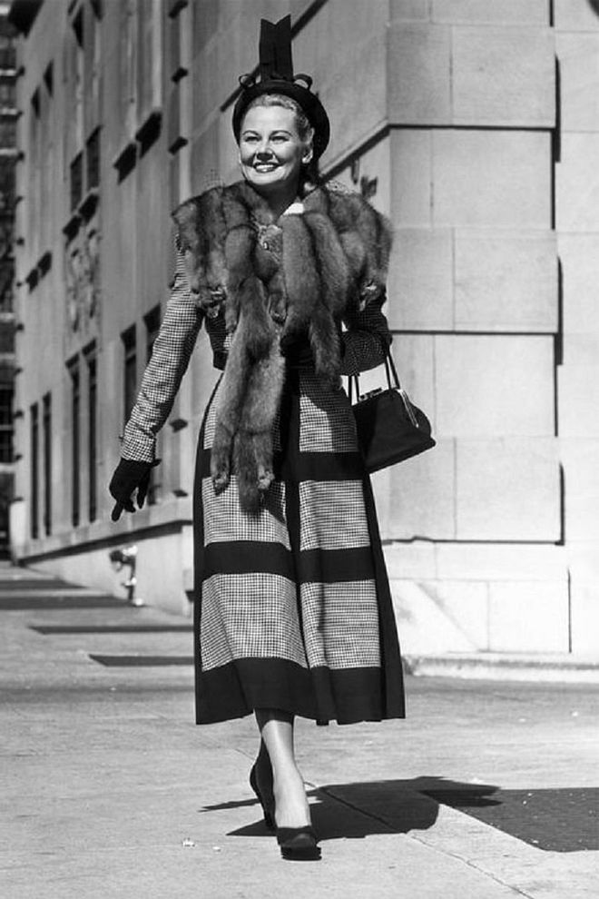 A woman wears a print dress and fur while walking down New York street.

Photo: Getty