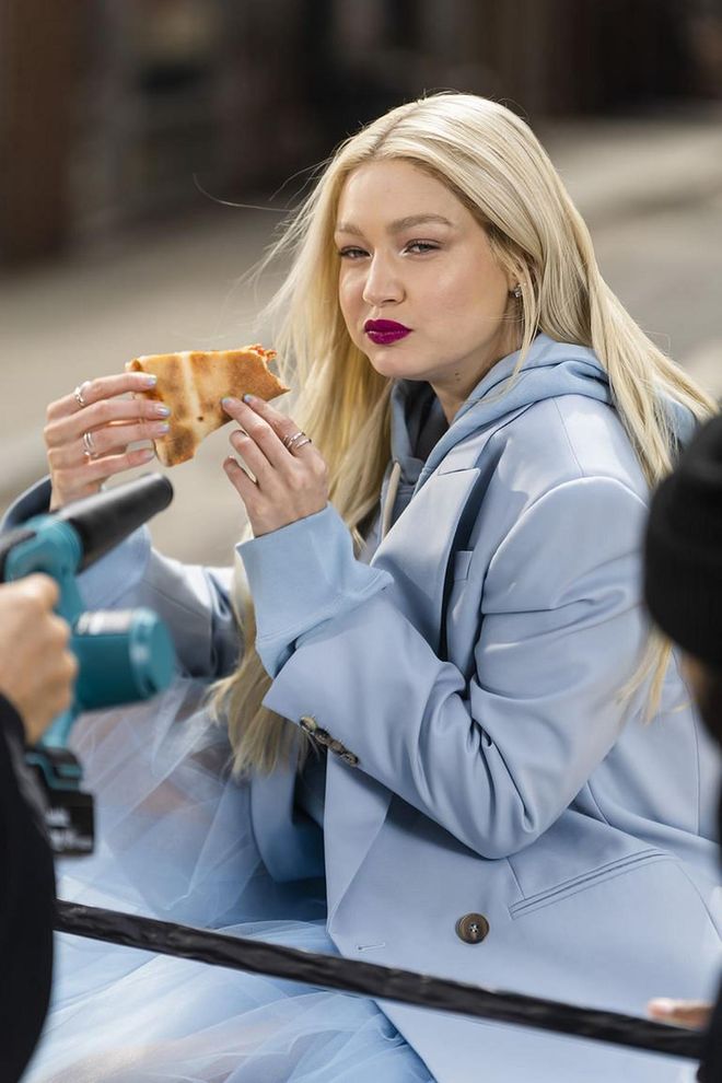 Gigi Hadid Eats Pizza In A Blue Princess Gown Behind The Scenes Of n NYC Photo Shoot