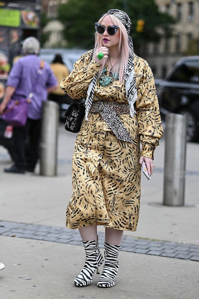 NEW YORK, NEW YORK - SEPTEMBER 11: Kristen Bateman is seen wearing a yellow animal print dress and zebra boots outside the Ulla Johnson show during New York Fashion Week S/S 2023 on September 11, 2022 in the borough of Brooklyn, New York. (Photo by Daniel Zuchnik/Getty Images)