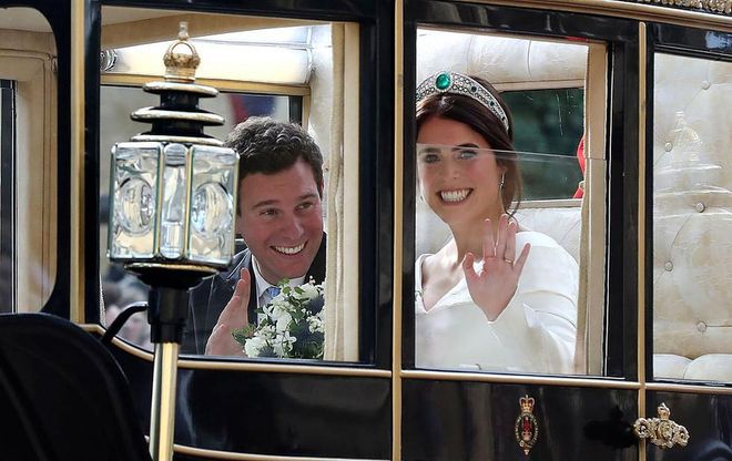 The newlyweds were all smiles as they rode in a carriage after their wedding.