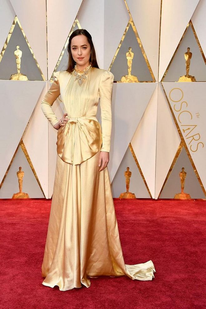 Dakota Johnson looked radiant ina  gold-toned satin Gucci gown at the 89th Annual Academy Awards. She paired the look with a vintage Cartier necklace (read: genius) and the subtle hue of her dress is just as wedding worthy as ivory. Fashion risk-takers take note: The look's high shoulders and draped waist keep this chic - and from skewing MOB. 