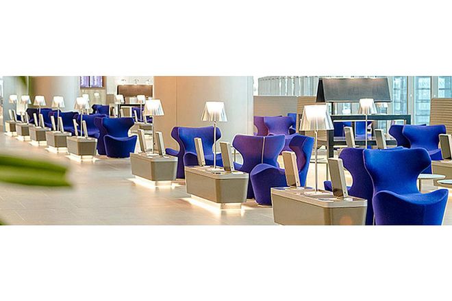 This massive lounge, where crowding is never a problem, features luxurious design touches like fine marble and designer furniture. In fact, each of the sleek blue chairs comes equipped with individual power outlets for charging devices, as well as a touchscreen monitor with airport and flight info. Travelers can just relax during the layover instead of scrambling to keep track of the latest flight updates. 