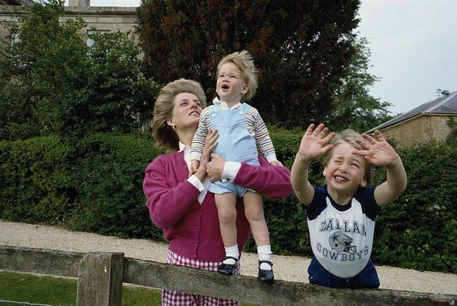 A wind-swept Prince Harry plays with his brother, Prince William, and Princess Diana at Highgrove House.
Photo: Getty