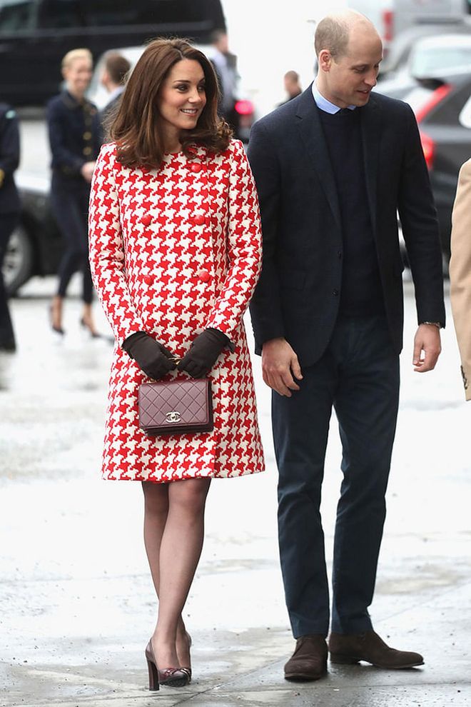 Kate wore a red houndstooth Catherine Walker coat with Tod's heels and a burgundy Chanel bag. Photo: Getty