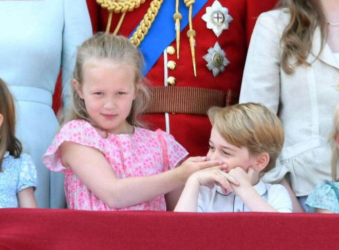 Savannah Phillips, the seven year old daughter of Peter and Autumn Phillips (Peter is the son of the Queen's daughter Princess Anne) is close to her second cousins, George and Charlotte, as evident by this Trooping the Colour photo of her silencing the heir to the throne, which went viral in June.