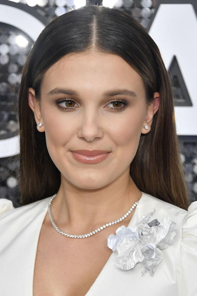 Millie Bobby Brown channelled traditional grown-up glamour, with long glossy hair extensions and soft smoky make-up. Artist Kelsey Deenihan used a combination of Pat McGrath Labs and the actress's own range, Florence by Mills, to master the look.

Photo: Frazer Harrison / Getty