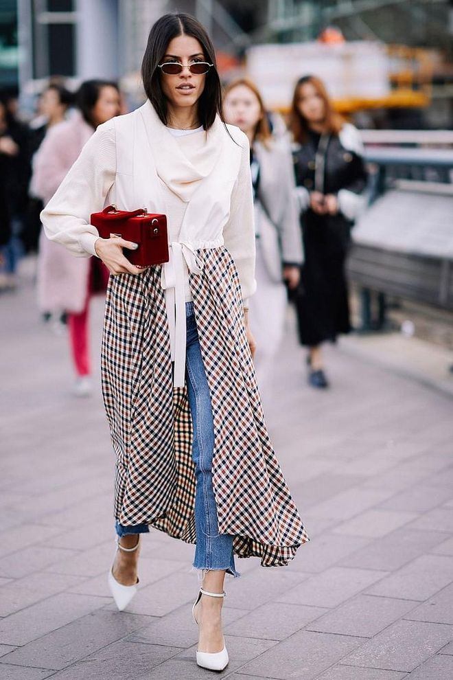 The biggest fear when wearing dresses over jeans is that you will end up looking bulky. To avoid this, choose floaty lightweight frocks rather than anything too chunky – and accessorise with delicate, ladylike shoes and bags. We'd also recommend sticking to a skinny or straight-leg style, rather than a flare. Photo: Getty 