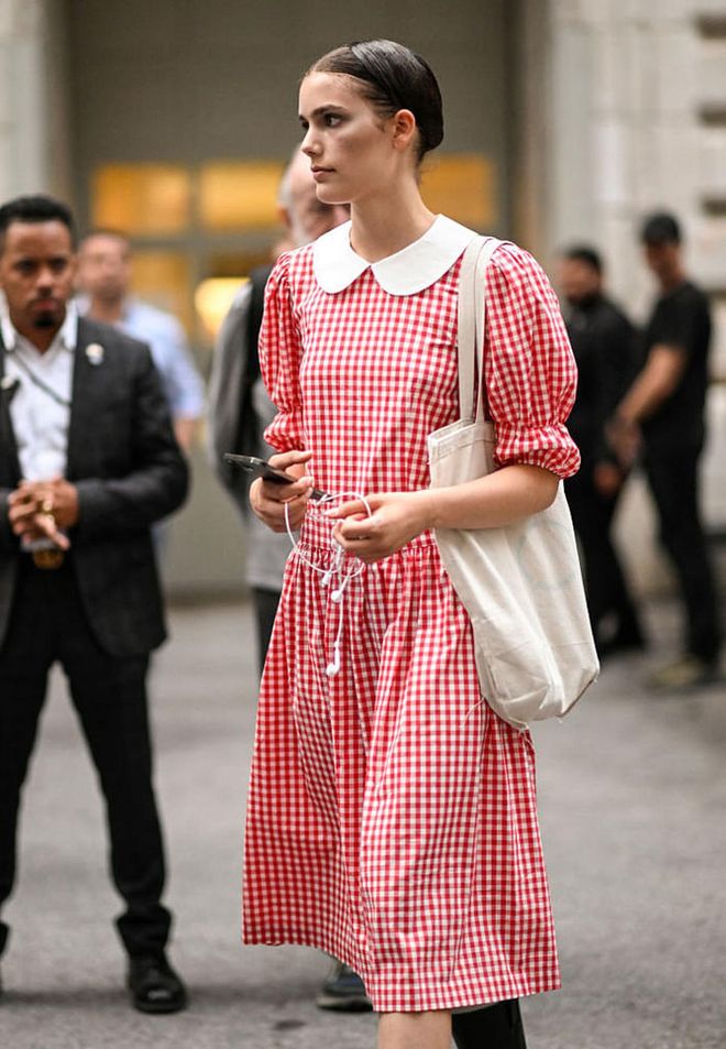 NEW YORK, NEW YORK - JUNE 26:  Model Betsy Gaghan is seen wearing a red and white plaid dress and black boots outside the Marc Jacobs show on June 26, 2023 in New York City. (Photo by Daniel Zuchnik/Getty Images)
