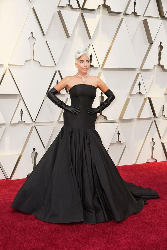 Lady Gaga channelled Audrey Hepburn in a breath-taking, custom, sculptural black gown by Alexander McQueen. She paired the look with a 128-carat Tiffany diamond necklace and perfectly Gaga elbow-length black leather gloves.