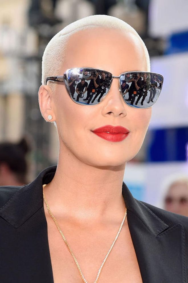 Rose's complexion looks extra glow-y against her bleach blonde buzz cut and a picture-perfect red lip.
