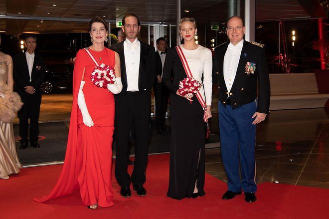 Princess Caroline of Hanover looks stunning in a red cape gown, accompanied to the night's Gala by her son Andrea Casiraghi, Prince Albert, and Princess Charlene, who looked regal in a black and white gown and statement earrings.

Photo: Getty