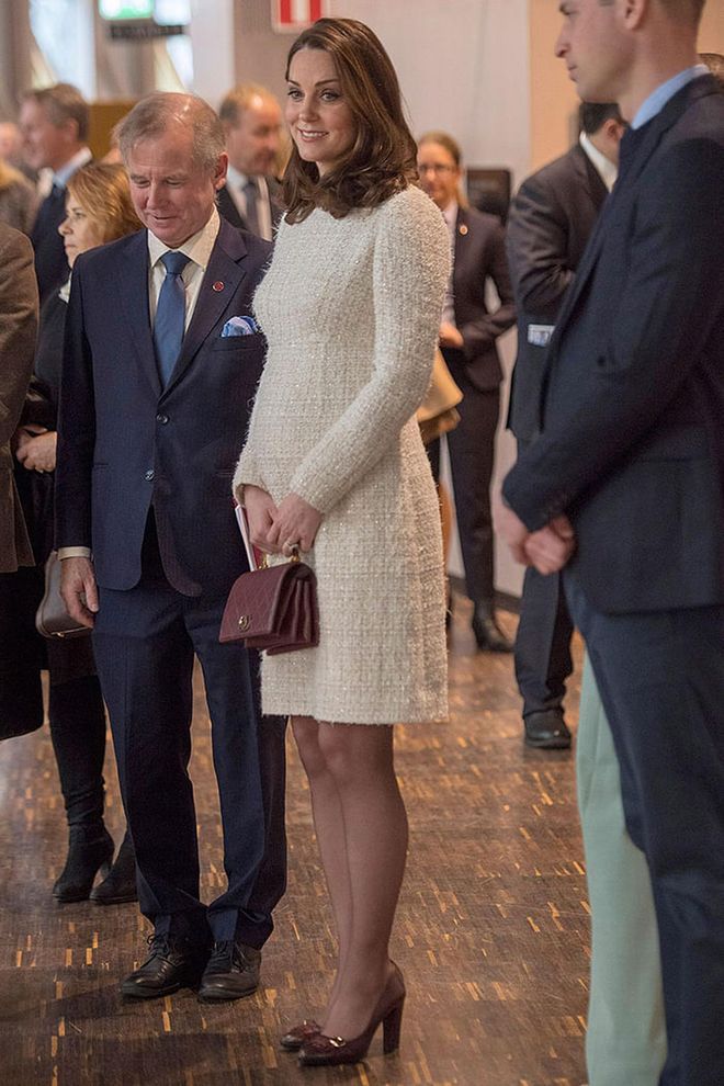 Kate Middleotn was wearing a white tweed Alexander McQueen dress underneath her patterned coat. Photo: Getty