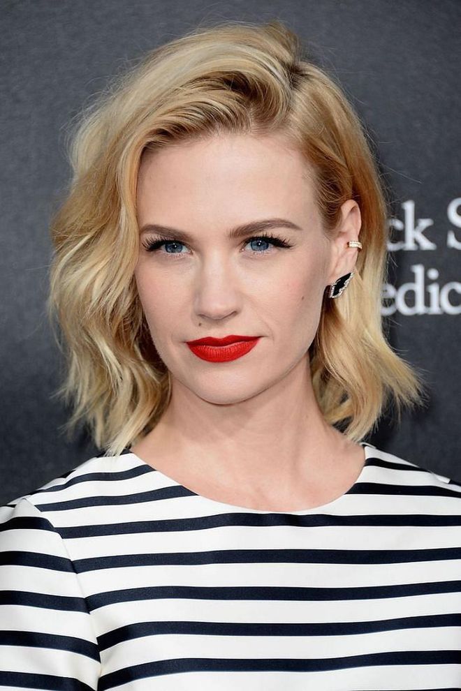 January Jones channels French girl vibes with casual waves flicked over the crown, red lips, and stripes.

Photo: Getty