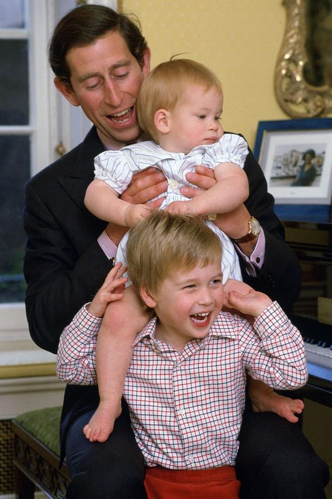 The royal couple welcomed Prince William in 1982 and Prince Harry in 1984. Here, Charles, the Prince of Wales has a silly moment with his two sons at home in Kensington Palace.