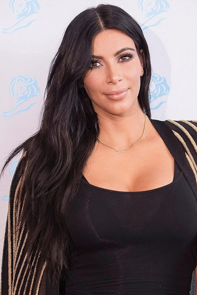 Kim Kardashian's sleek center parts add drama to her long piecey strands. Photo: Getty 