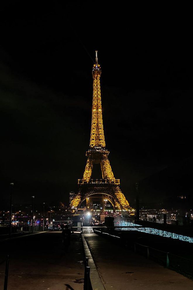 Outside the YSL show, the Eiffel Tower lights up the night.