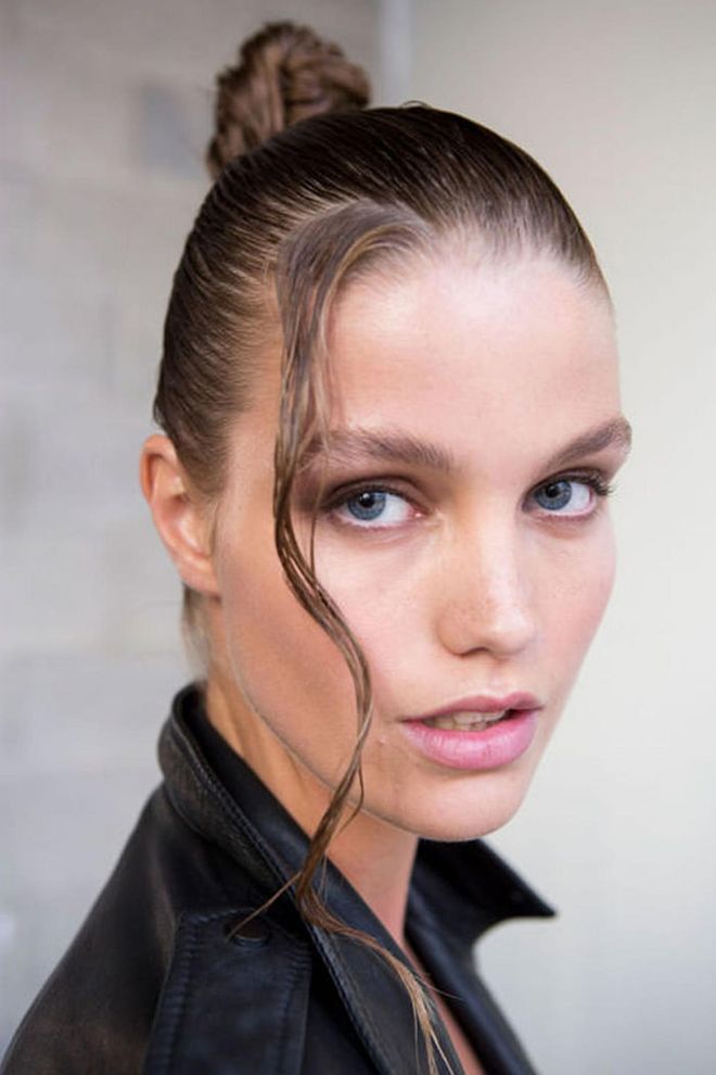 The Look: Wet Hair, Don't Care
How-To: When you think of beachy hair, you don't really think of the look hairstylist Odile Gilbert created at Thakoon. But it was '80s supermodel Yasmin Le Bon on the beach in the Bahamas that served as the inspiration for the wet and shiny knots seen backstage. Gilbert used gobs and gobs of Kérastase Crème de la Crème blow-dry cream to totally drench the hair. After twisting it up and securing a bun high on the head, a small face-framing piece was untucked at the front. For Gilbert, the addition of the hanging piece was meant to add a sexy allure. For us, it grounded the whole look in reality: true beachy hair should never be too perfect, after all. Photo: IMAXTREE