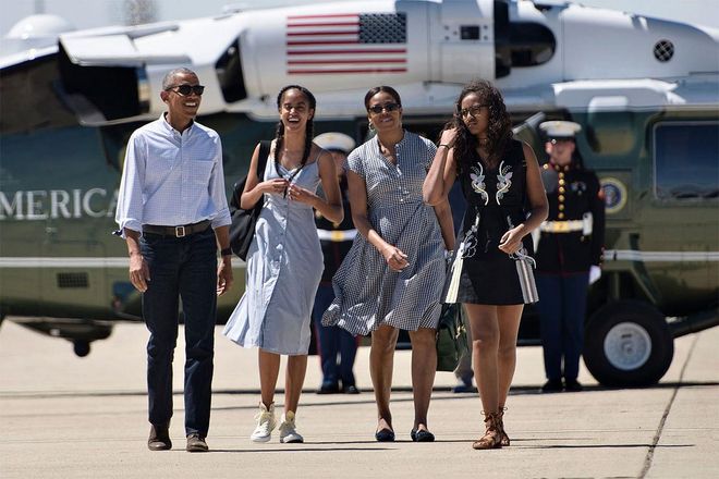 The Obama family heads for Air Force One in colour-coordinated summer outfits. Photo: Getty