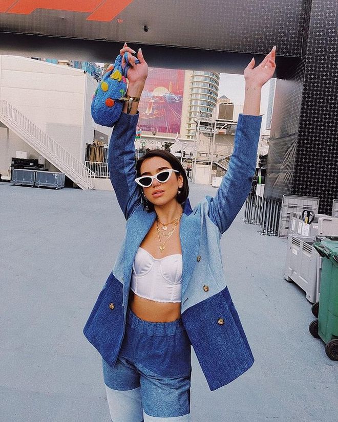 While in Azerbaijan for the Formula 1 Grand Prix, she had on a patchwork denim ensemble by Ksenia Schnaider on top of a Jessica Choay corset. Her Ganni beaded bucket bag was a cute addition to the look, and signed off with her favourite
Le Specs x Adam Selman sunglasses and Shami necklaces.
Photo: Instagram
