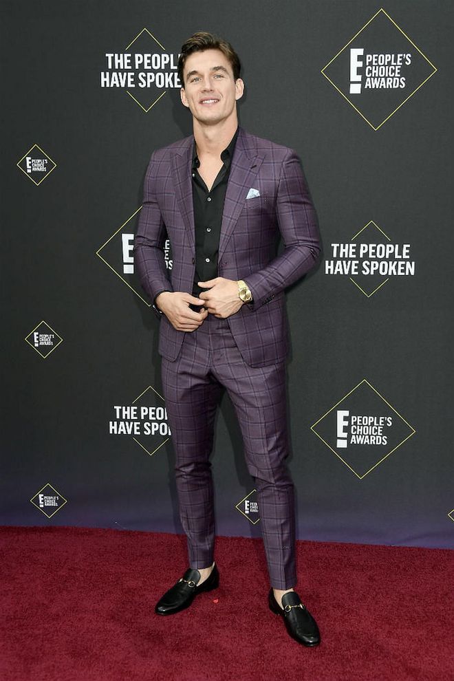 Tyler Cameron wears a purple gingham-printed suit from bespoke label Amin Standard.

Photo: Getty