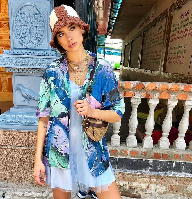 In Kuala Lumpur, Malaysia, she explored caves and touched murals while wearing this adorable Acne Studios shirt and Daisy satin tulle slip combo. She used a Balenciaga belt pack, had on a handmade Loewe knit hat, and wore a delectable collection of Shami necklaces.
Photo: Instagram
