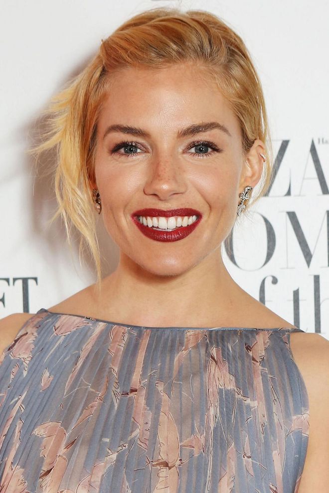 For times when you can't be bothered, pin 'em back to the side, give the ends a bit of wave and dress up the look with deep red lipstick. Photo: Getty