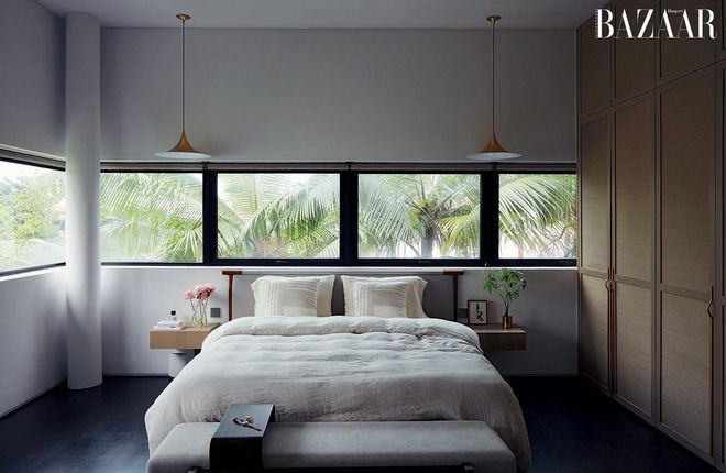 Her bedroom evokes a calming aura, thanks to views of greenery and neutral bedding in soft textiles.