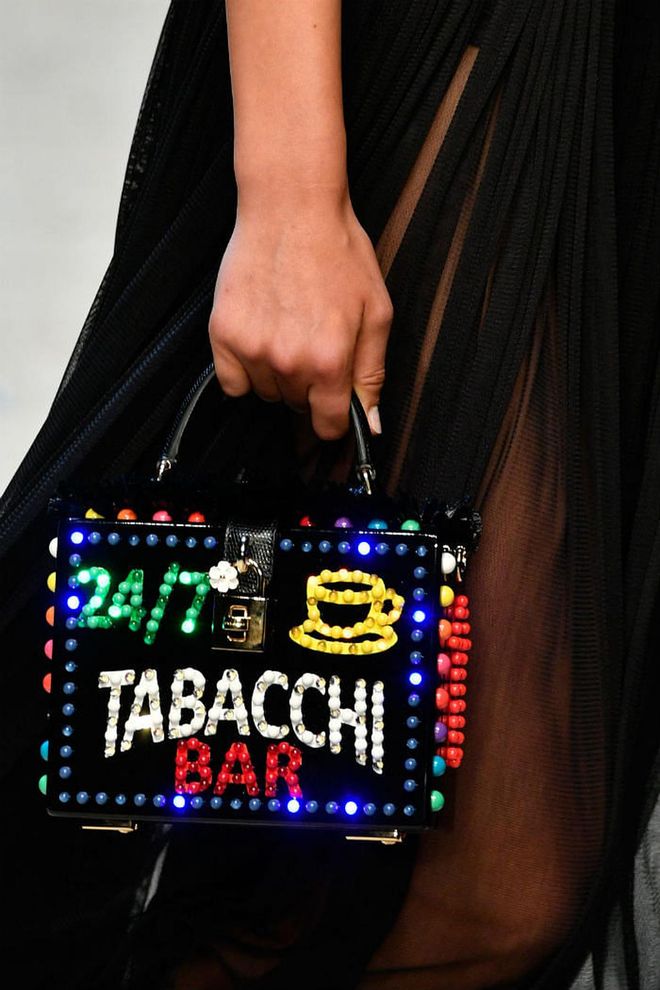 Seen at: Milan Fashion Week//Why we love it: Top handle bags in a miniature size is the perfect recipe for an arm candy. With the kitschy details reminiscent of good times at the bar, this number is just made for those who know what it means to have fun. (Photo: Getty)