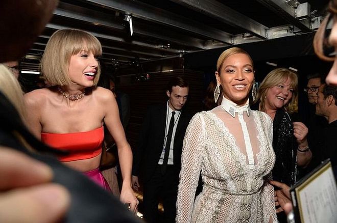 In this backstage photo, Beyoncé shares a laugh with Taylor Swift. Oh, to be BTS at the Grammys. 