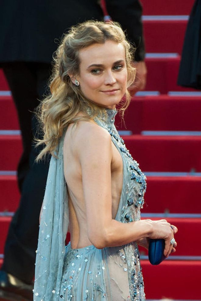 For flowing princess-y waves like Kruger's, go to town with a curling iron and secure your hair back above your ears. Photo: Getty