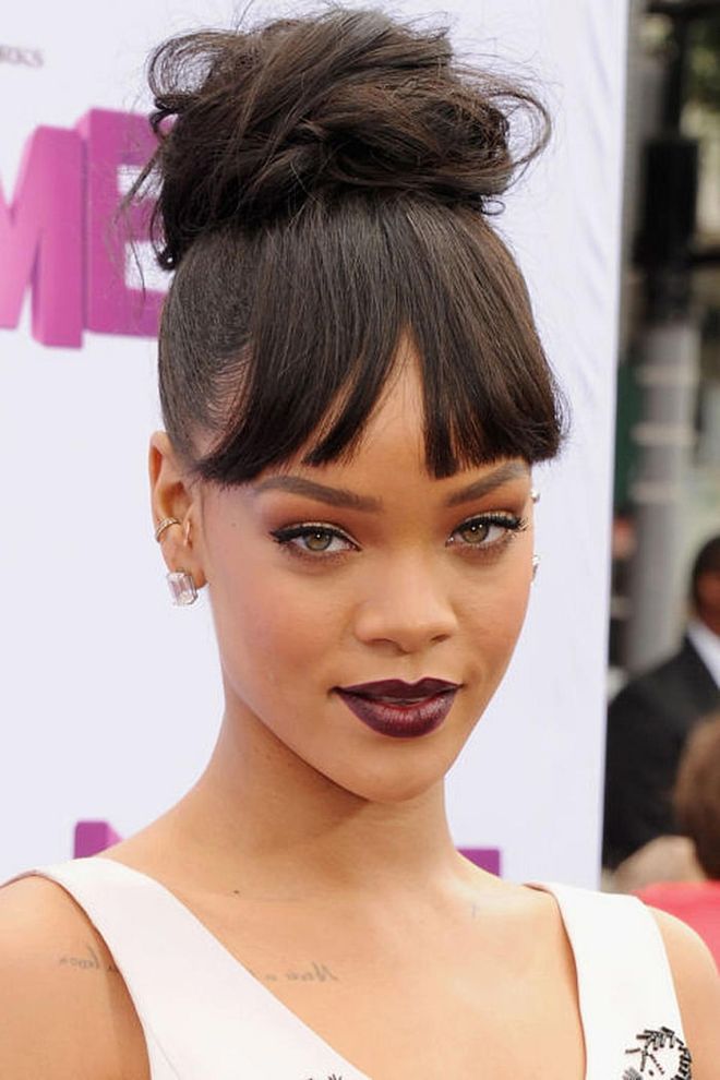 Rihanna's modern-day Cinderella style is a tale of two textures: sleek bangs offset a chic, chunky bun.