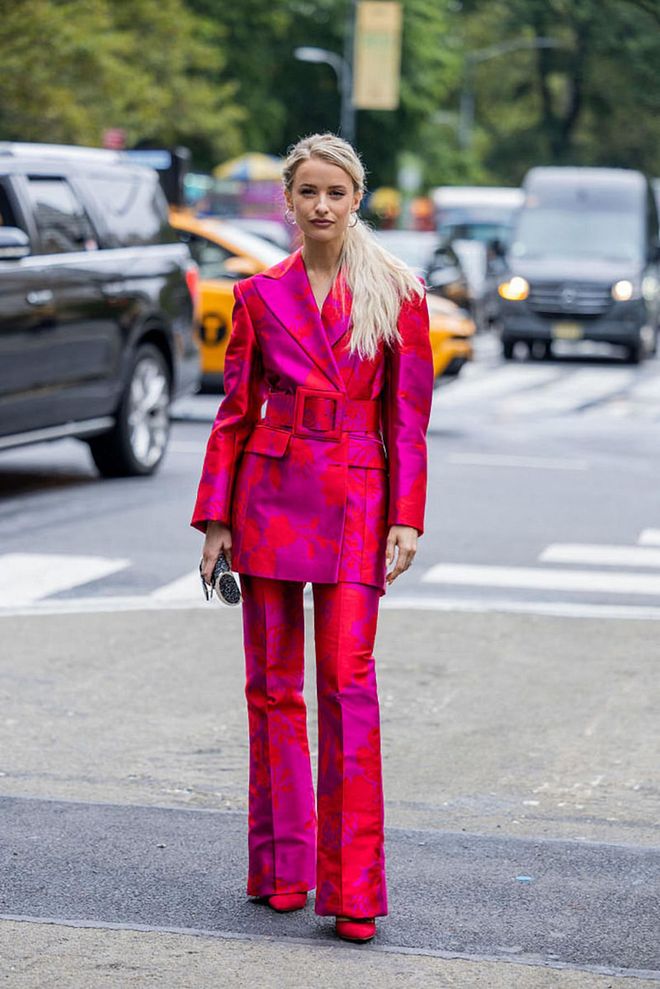NEW YORK, NEW YORK - SEPTEMBER 13: Victoria MagrathNew wearing a full hot pink outfits of same pattern, including a blazer with a belt, pants and heels. (Photo by Christian Vierig/Getty Images)