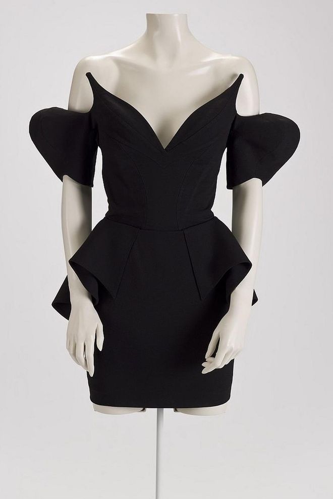 Here, French designer Thierry Mugler takes exaggerated silhouettes and puts them into one simple dress. The peplum is a reference to 19th century clothing, and combined with its low neckline, represents “power dressing,” which came to rise in the 1980s. Photo: Thierry Mugler