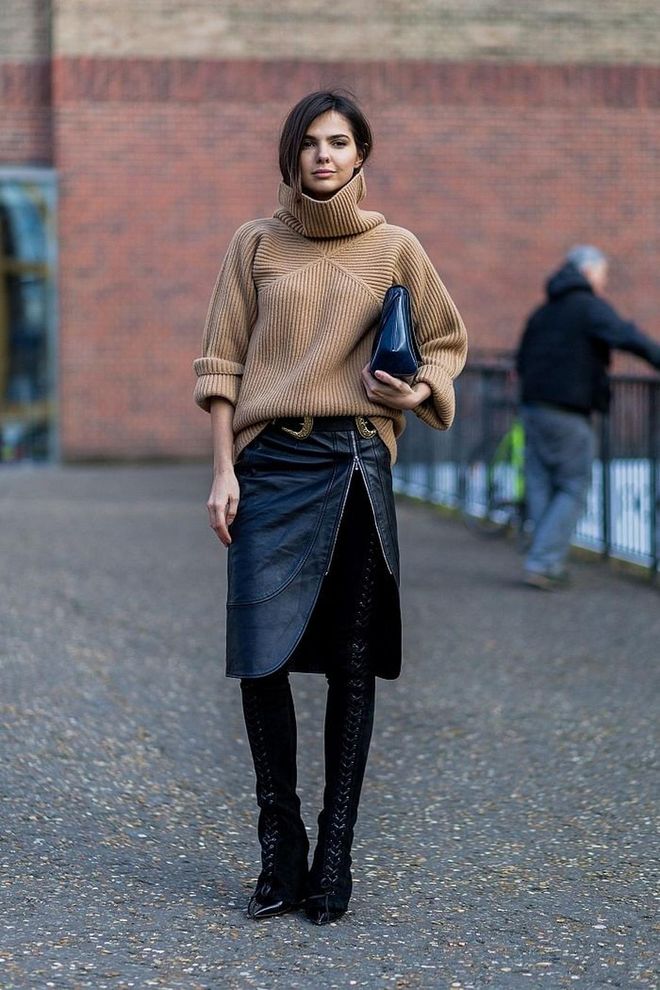 Play with textures by styling thigh-highs with an oversized knit. If you want to wear thigh-highs by day, the trick is to dial down their sexiness and team them with more ordinary pieces. Photo: Getty