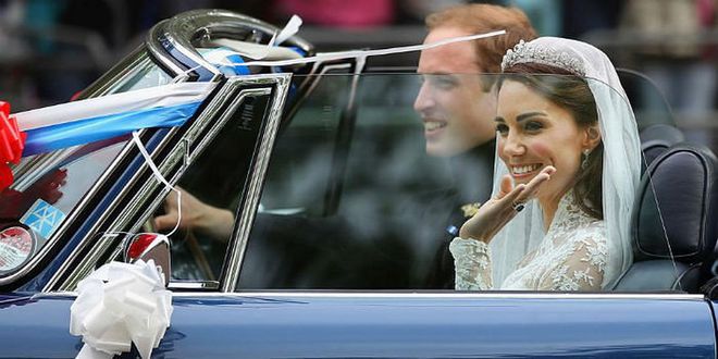A beaming Kate waves to the crowd from the couple's car.
Photo: Getty
