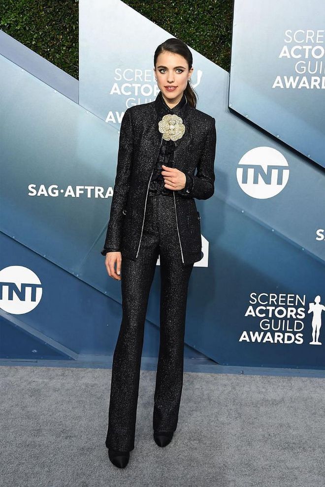 What: Chanel

Why: An evening suit worn perfectly. The iridescent black wool crepe jacket and pants, with an iridescent navy silk blouse, does its part to make this young actress shine; but it's that Chanel camellia brooch that really brings the glow.