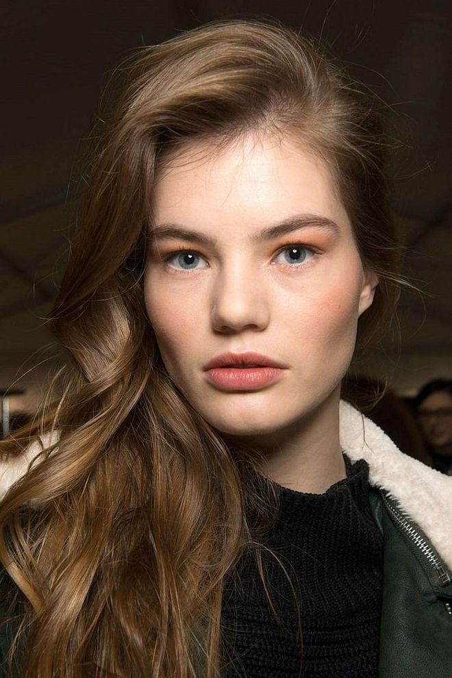 At Max Mara, models had their hair curled and fluffed and then flipped over to the opposite side, to achieve extreme height at the root.