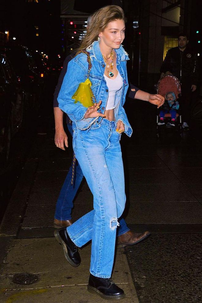 Gigi wore a denim jacket, straight-leg jeans, white tank top, Dr. Martens boots, layered necklaces and a yellow transparent bag to her birthday party in NYC.