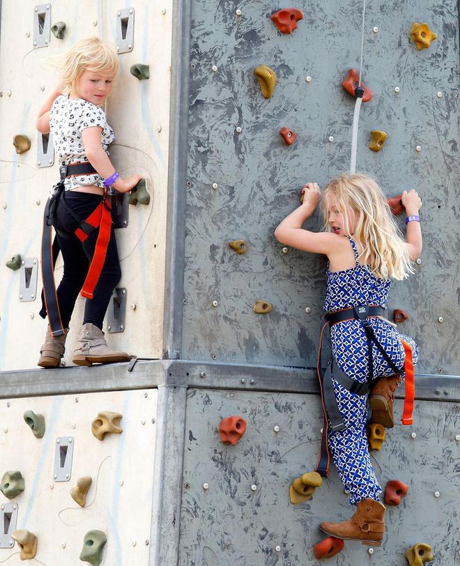 Sisters Isla and Savannah Phillips go rock climbing while at the Royal Windsor Horse Show as their parents, Peter and Autumn, look on.
Photo: Getty 
