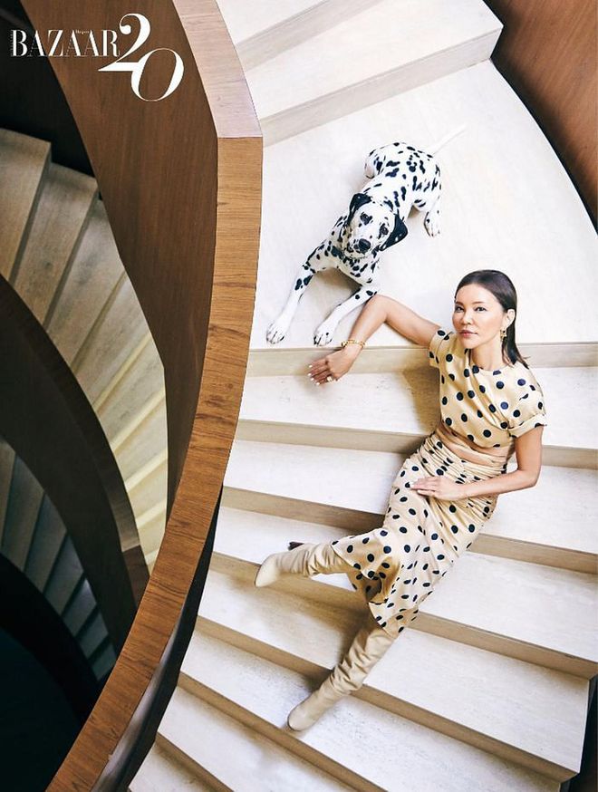 Lee (with her Dalmatian Neo) wears her own Orseund Iris dress, Saint
Laurent boots, Tiffany & Co. earrings, bracelet and rings, and Cartier ring.