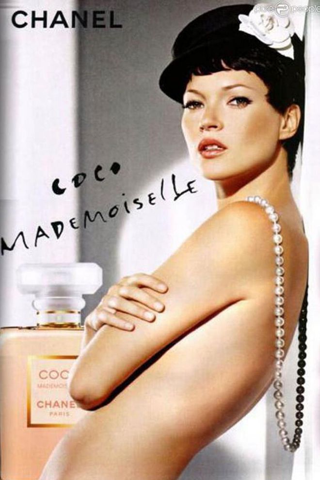 The Coco Mademoiselle campaign sees Moss taking beauty cues directly from Coco Chanel herself— in a short black wig topped with Chanel's favorite flower, the camellia. 