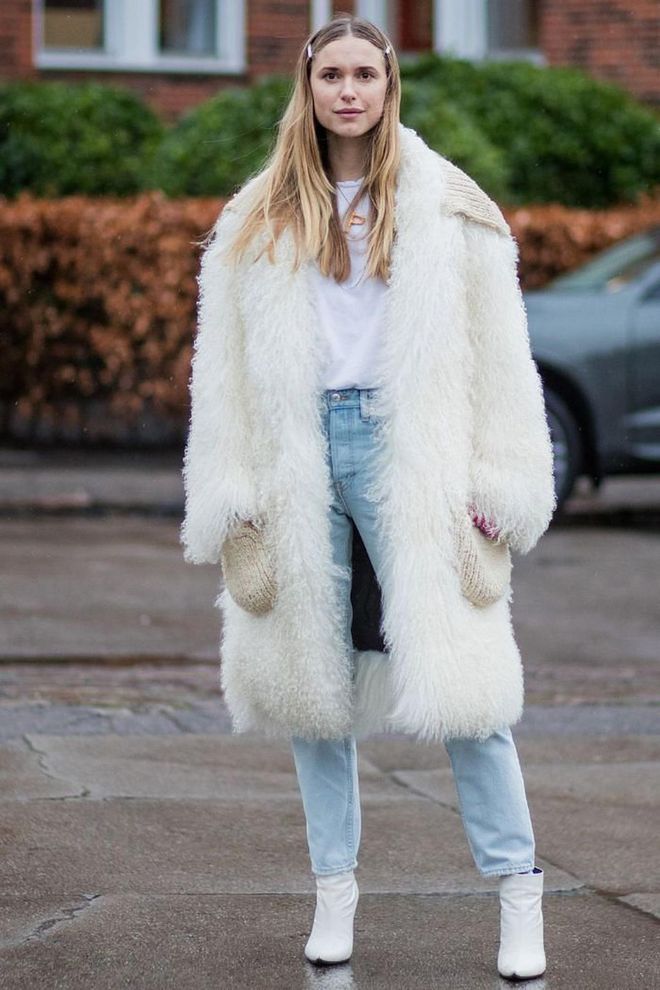 Black leather tends to look a little harsh next to a light-wash denim so make like Pernille Teisbaek and team it with white booties instead.

Photo: Getty