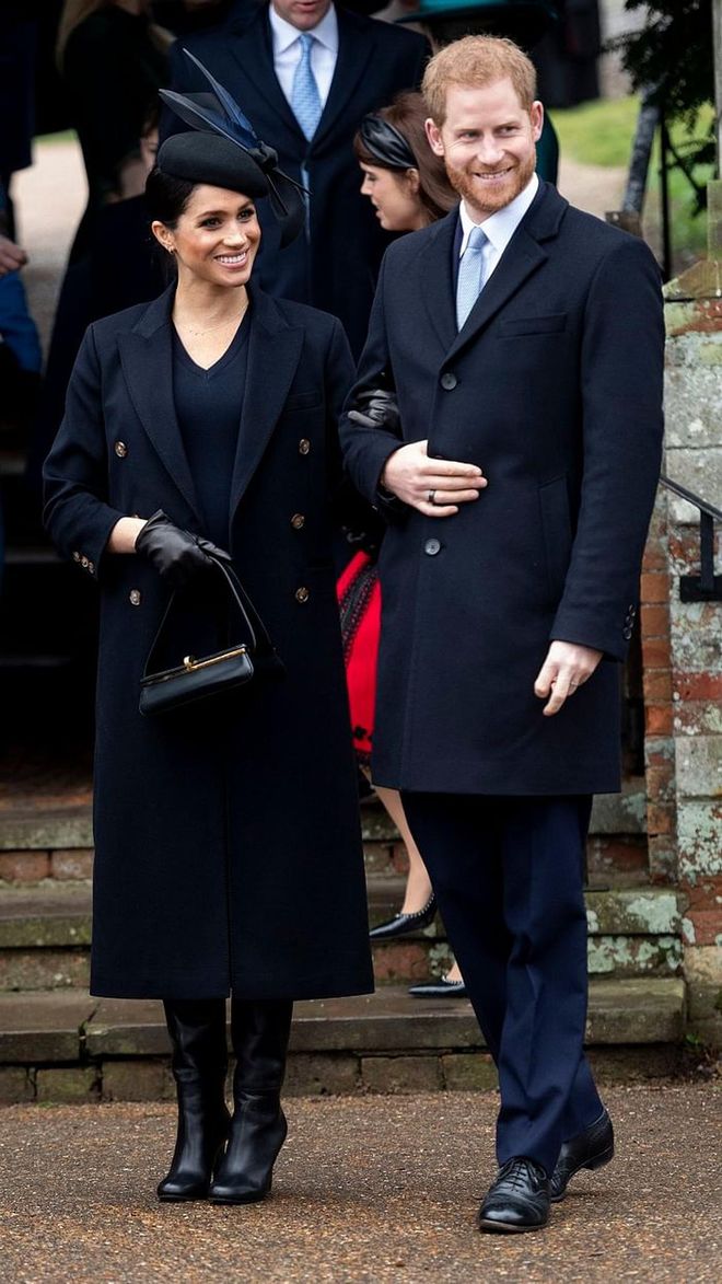 Meghan wore a top-to-toe navy ensemble that matched perfectly with Prince Harry on Christmas Day. Her entire outfit, including the stunning navy coat and boots are by Victoria Beckham, a royal family friend. 