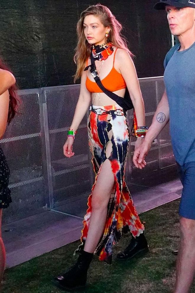For the first weekend of Coachella, Gigi opted for an orange Summersalt Voyager bikini with a tie-dye skirt, matching scarf, crossbody bag, and black ankle booties.
