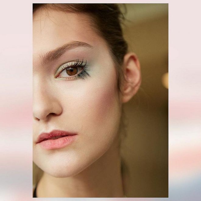 A dramatic pair of false lashes usually calls for eyeshadow equally as bold: glitter, black eyeliner, you get the idea. Which is why we love the look at Armani's couture show. Segmented false lashes popped unexpectedly against a canvas of watercolor, sky-inspired eyeshadow hues.
