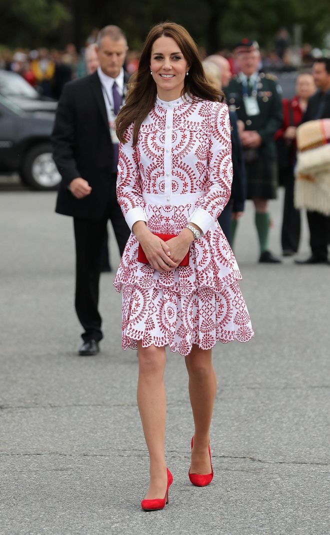 For Day 2 of the Royal Tour, the Duchess visited the Immigrant Services Society wearing a red-and-white eyelet Alexander McQueen dress with scarlet-red pumps, a coordinating clutch, and pearl earrings. Pure class. Photo: Getty