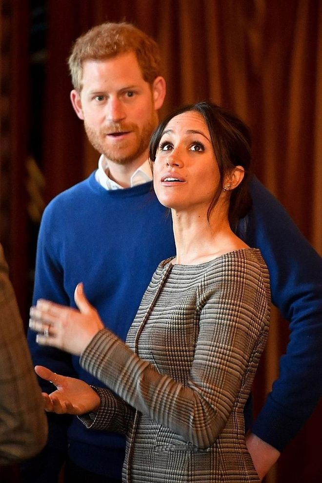Inside the coat, Meghan wore a plaid off-shoulder jacket/top by Theory and black skinnies. Chic, with a hint of sexy sophistication! Photo: Getty 
