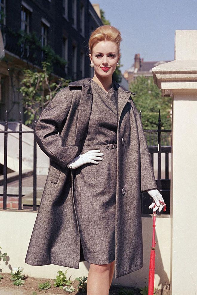 In a matching dress and overcoat with white gloves. Photo: Getty 